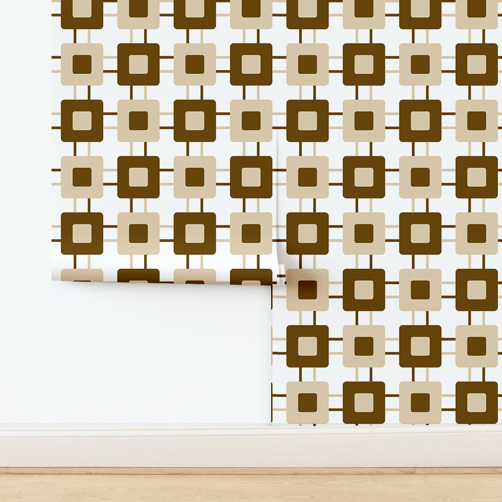 The artwork features a repeating geometric pattern of symmetrical shapes resembling elongated, curved diamonds or petals in various shades of blue and green. Each shape is split vertically with one half filled with a light blue and the other half filled with green or darker blue. The background is a light, almost pastel blue, which provides a soft yet vibrant backdrop. One of the blue shapes near the upper left contains a white starburst element, adding a focal point of brightness to the composition. The overall design conveys a modern, mid-century aesthetic with clean lines and harmonious color contrasts.